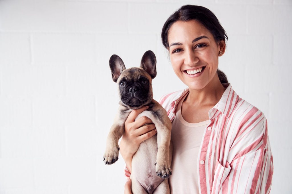 Woman holding her French Bulldog